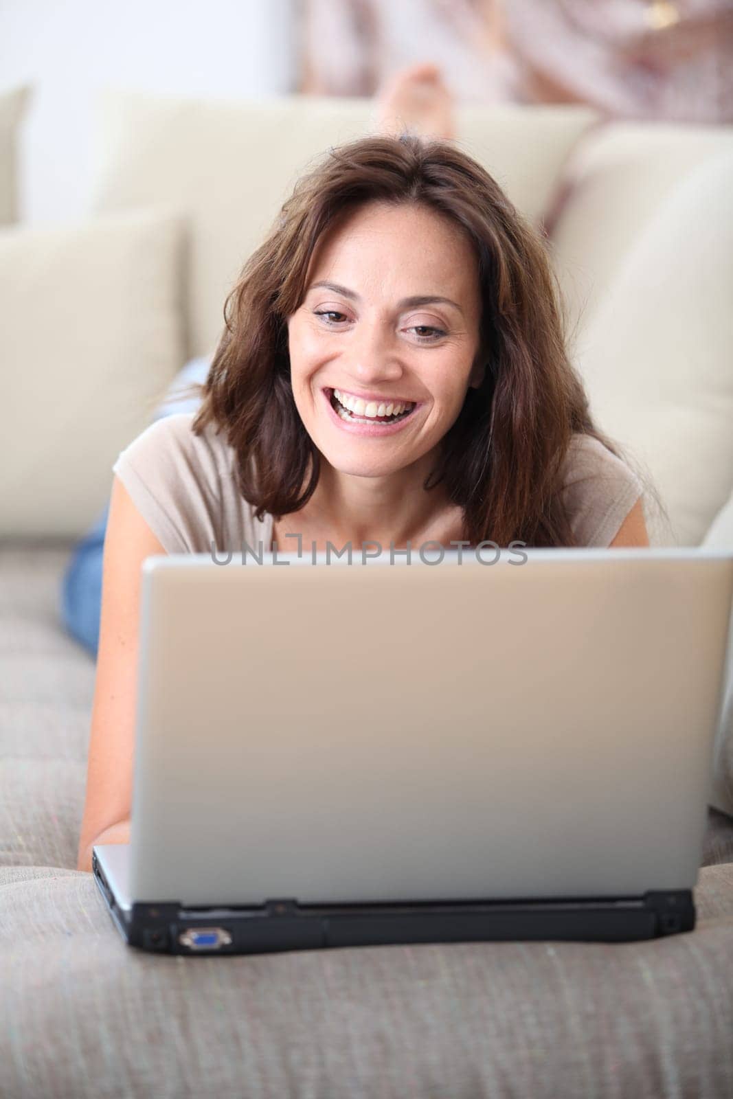 Woman on couch with laptop computer