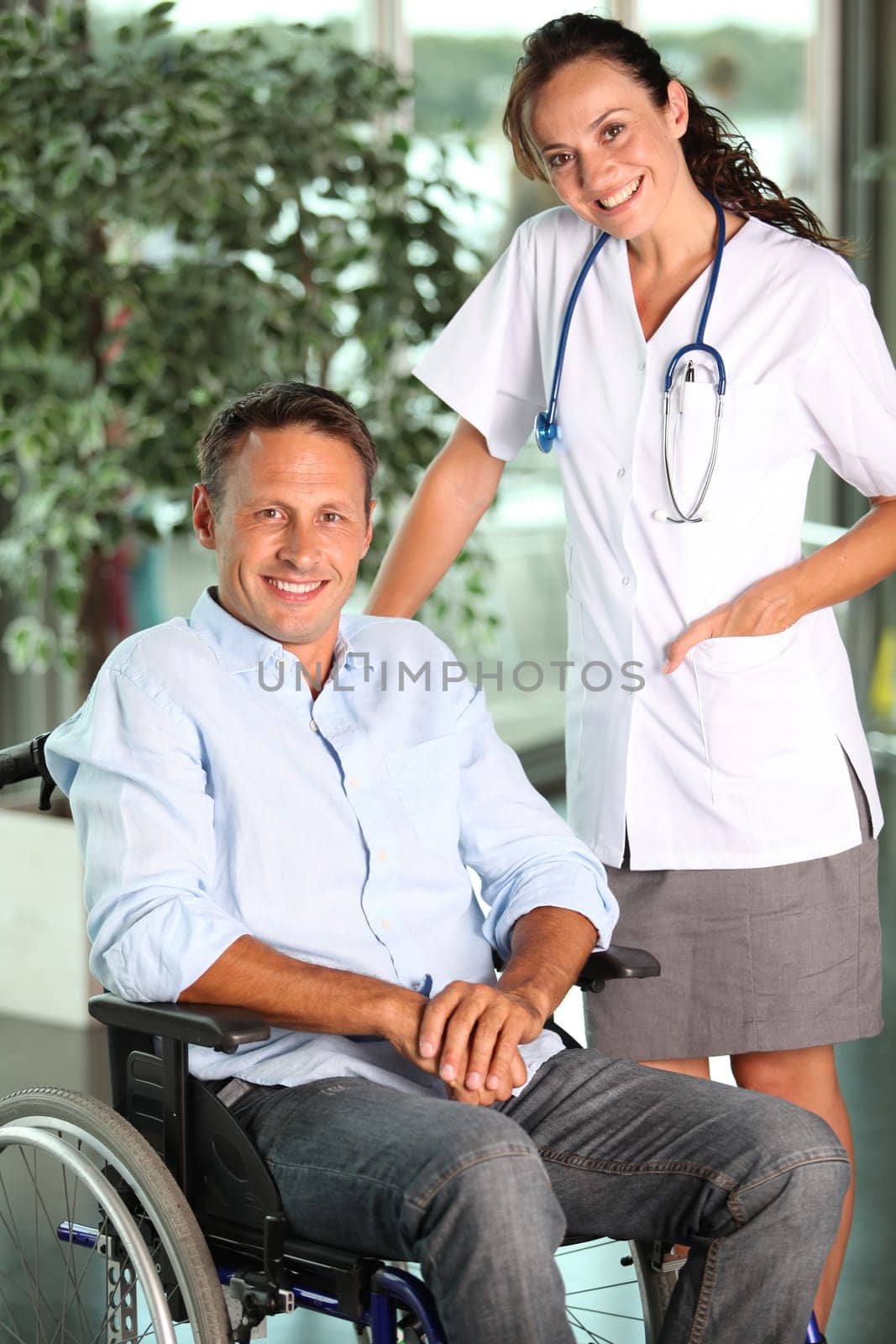Man in wheelchair with doctor in hospital