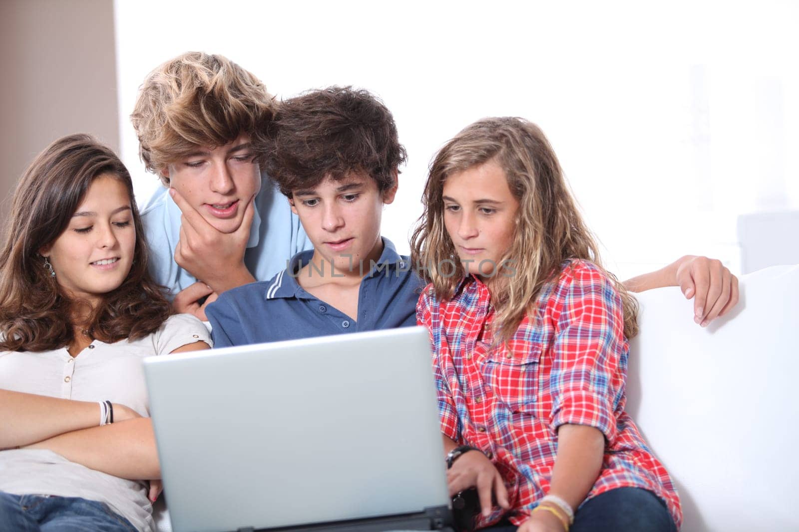 Group of teenagers at home with laptop