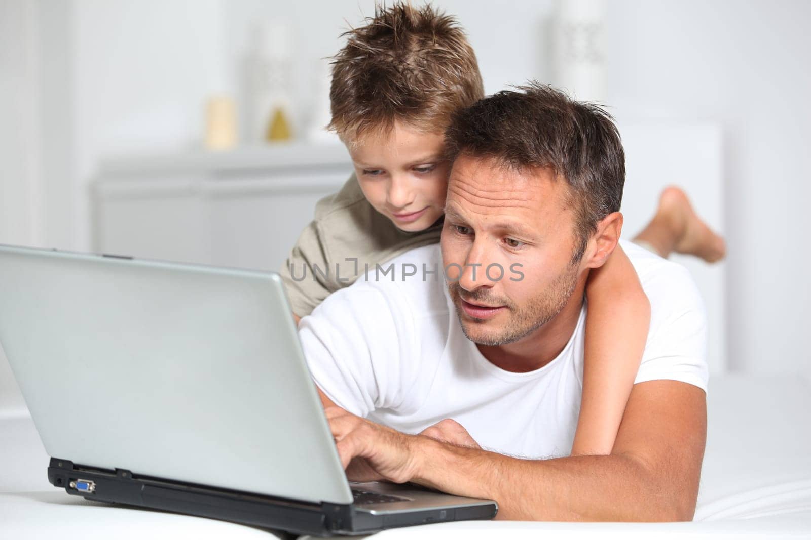 Father and son connected on internet at home