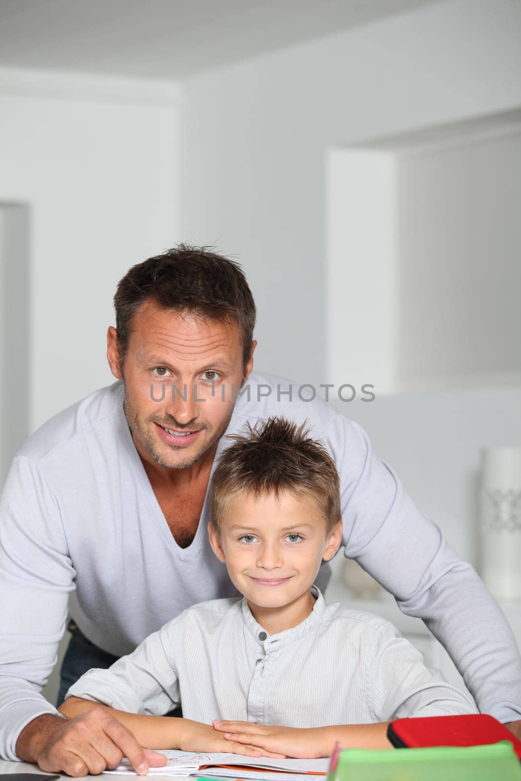 Father helping son to do homework
