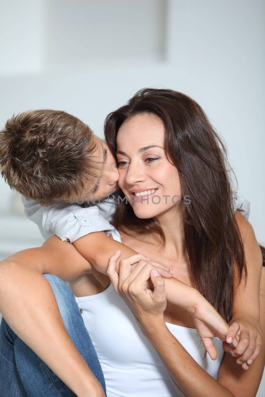 Little boy kissing her mom