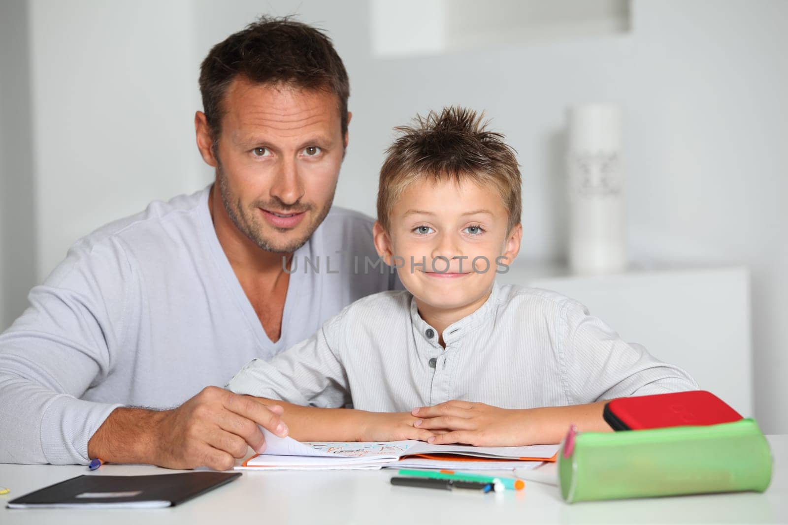 Father helping son to do homework