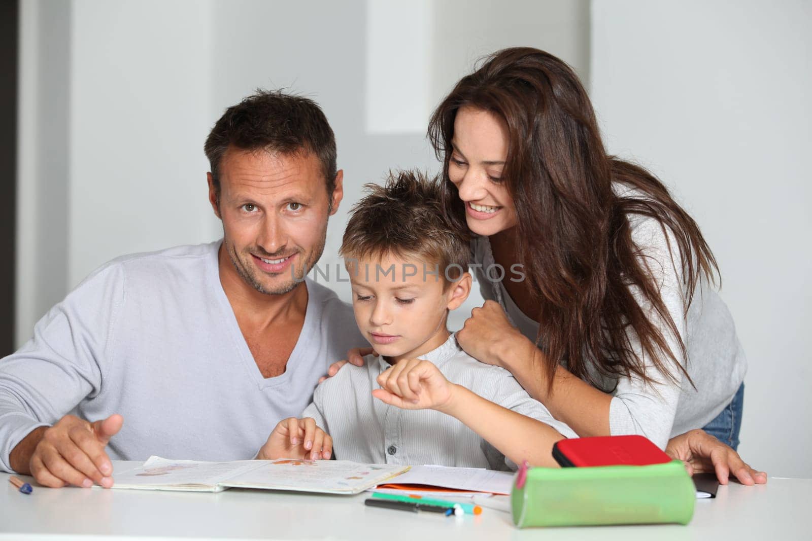 Parents helping son to do his homework
