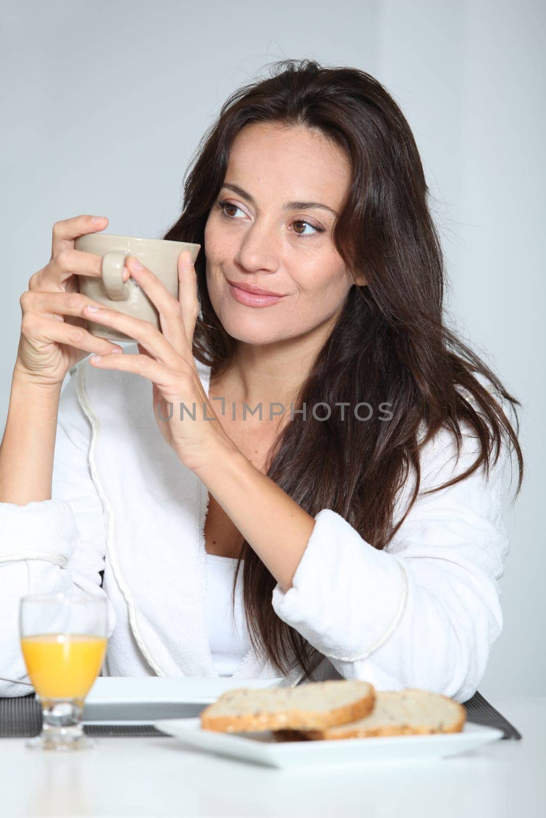 Beautiful woman having breakfast at home