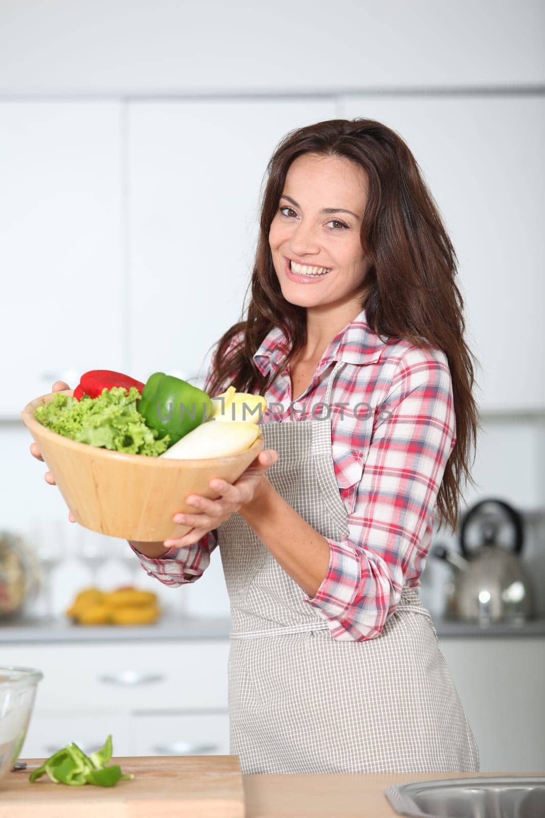 Beautiful woman stading in kitchen with apron