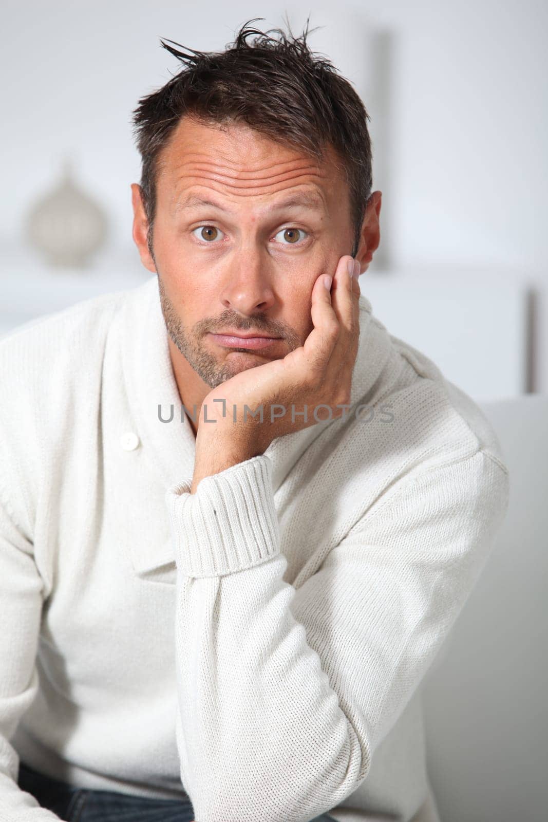 Closeup of hansdsome man with white sweater
