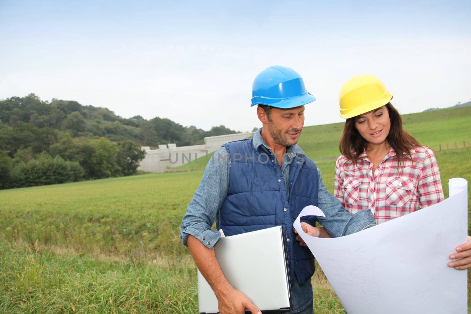 Business people checking plan on construction site