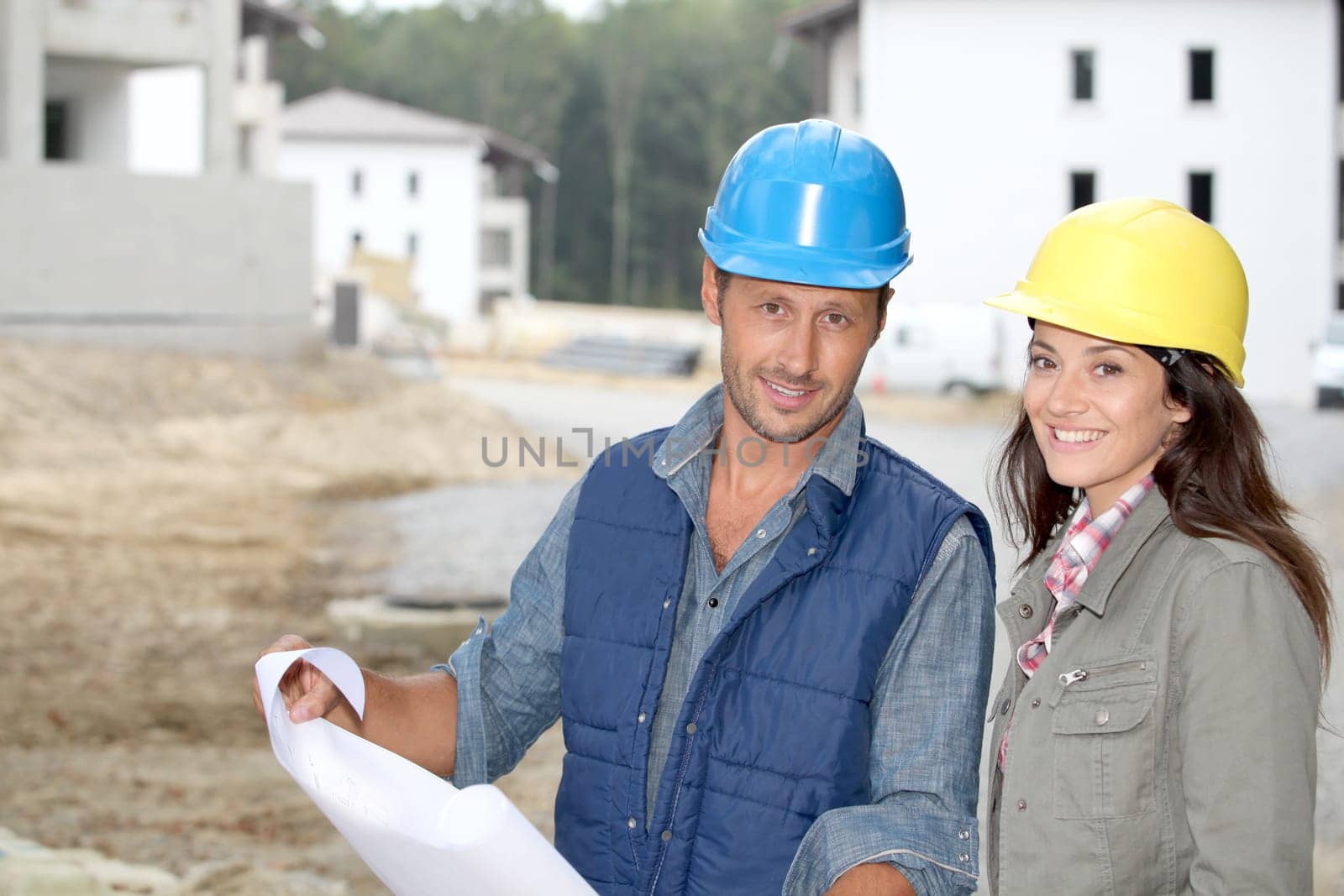 Team of architects checking plans on site