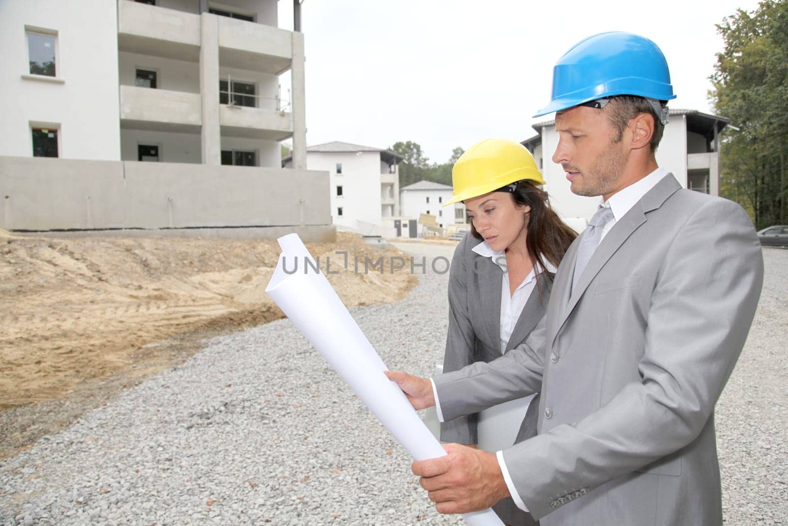 Team of architects checking plans on site