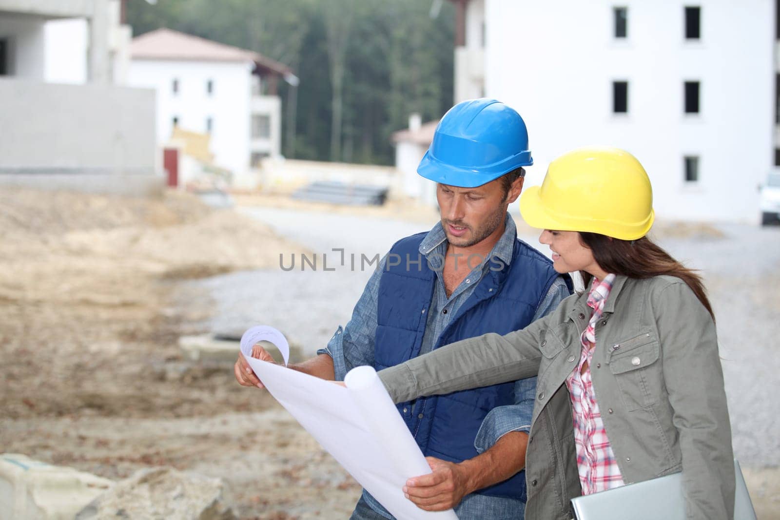 Team of architects checking plans on site