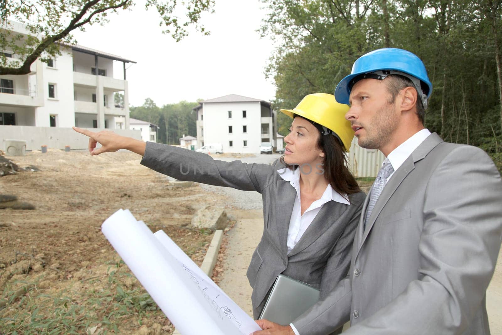 Team of architects checking plans on site
