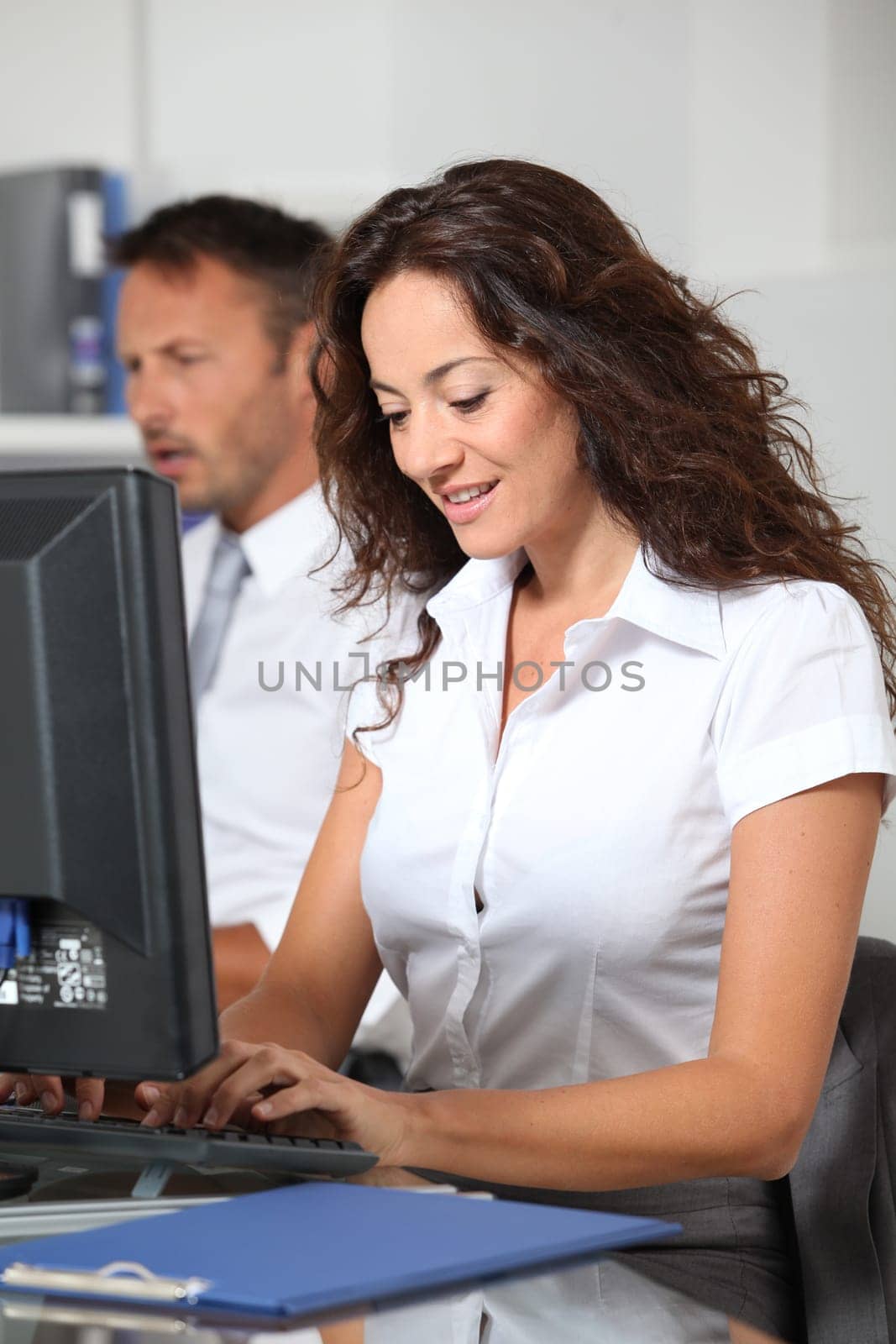 Beautiful woman typing on computer desk