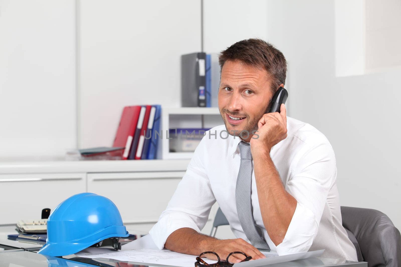 Site manager in the office with blue helmet