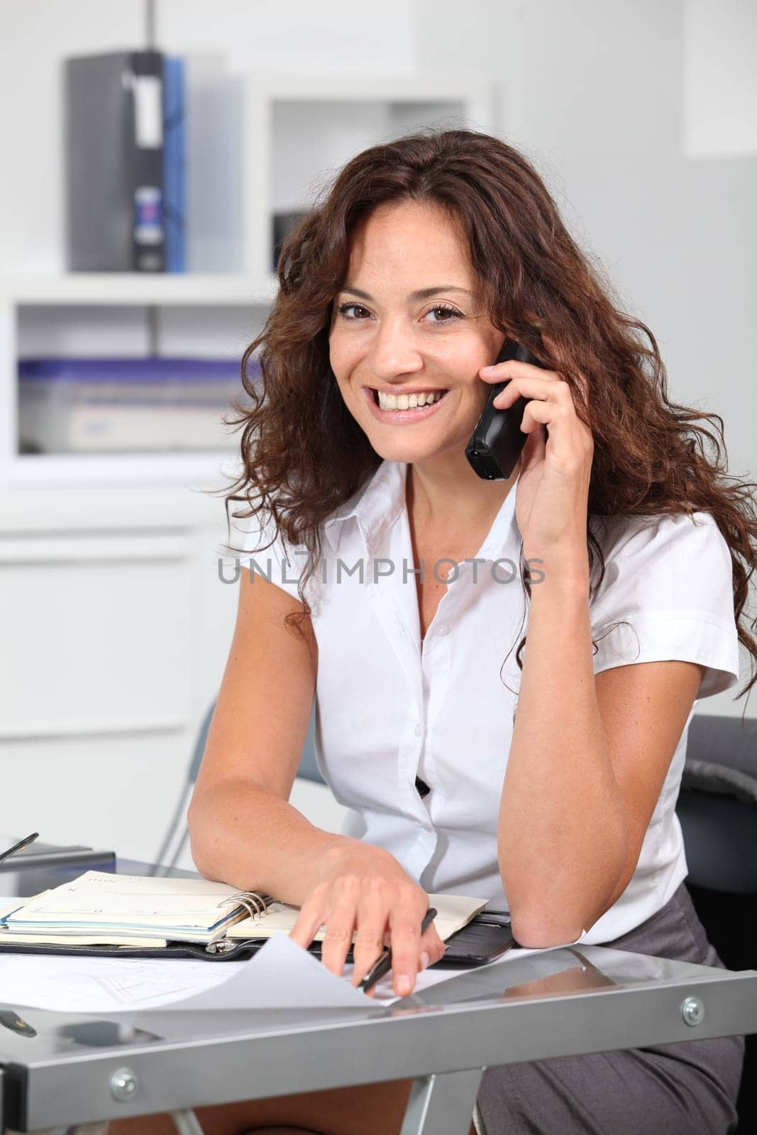 Closeup of businesswoman in the office talking on the phone