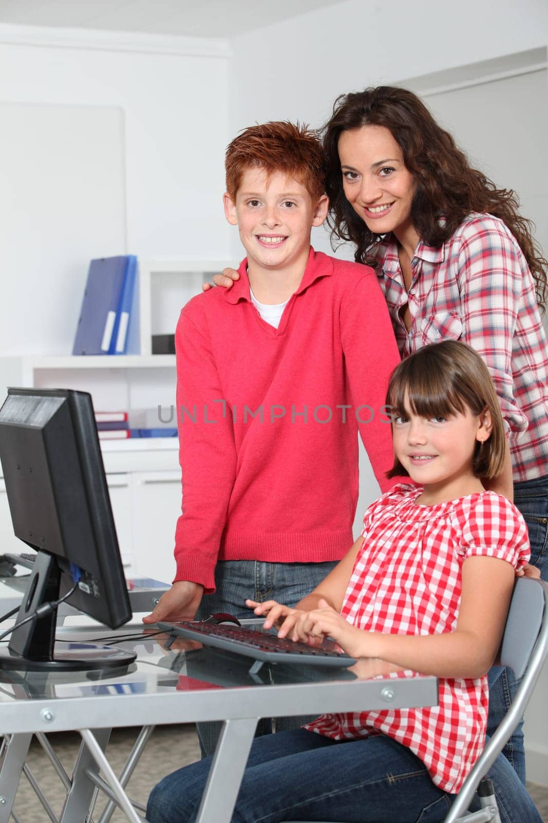 Teacher and children learning to use computer