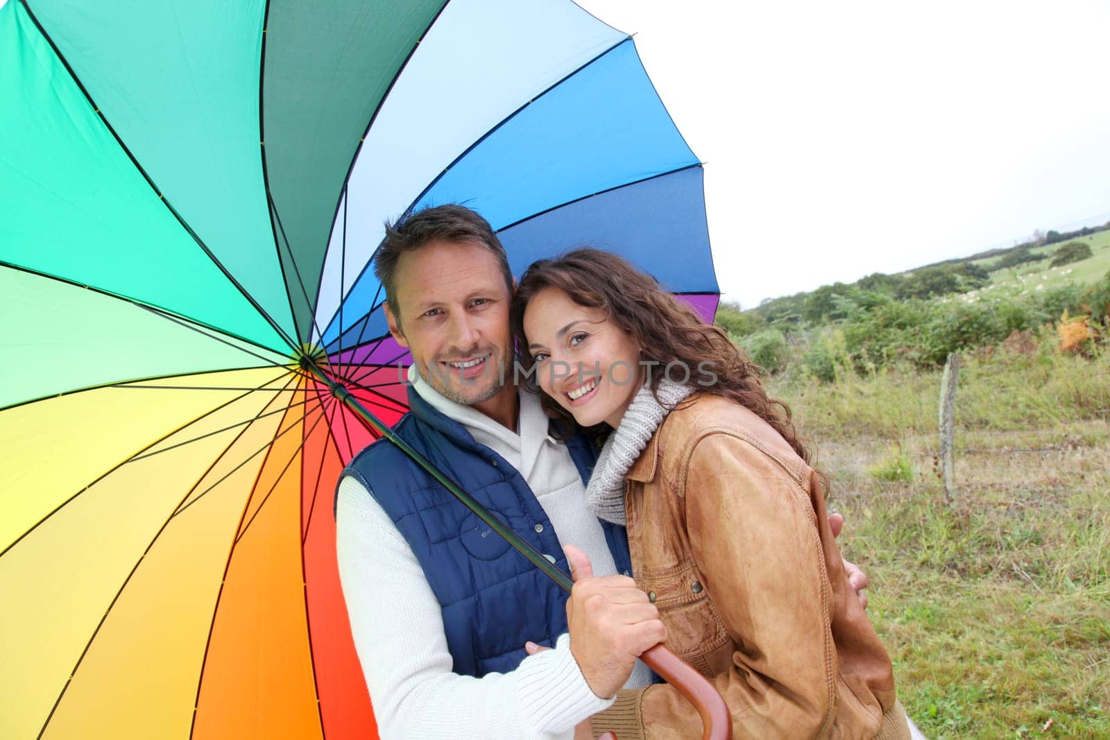 Smiling couple on a raining day