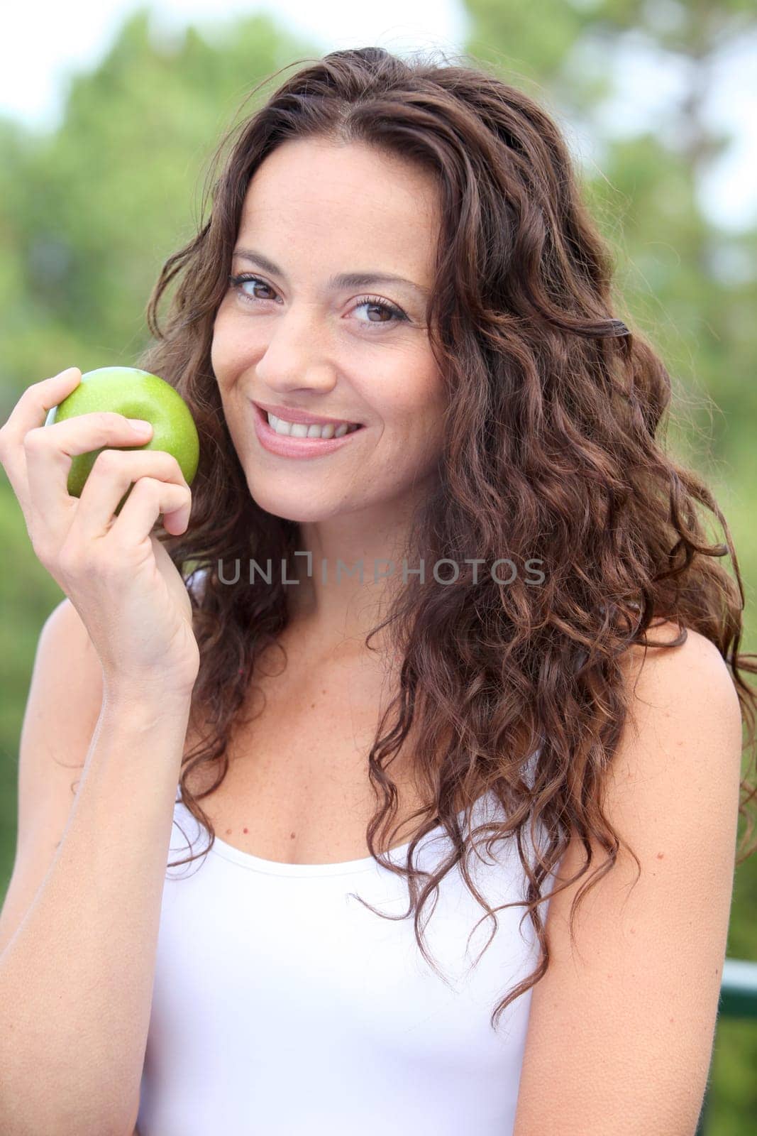 Closeup of woman eating a green apple
