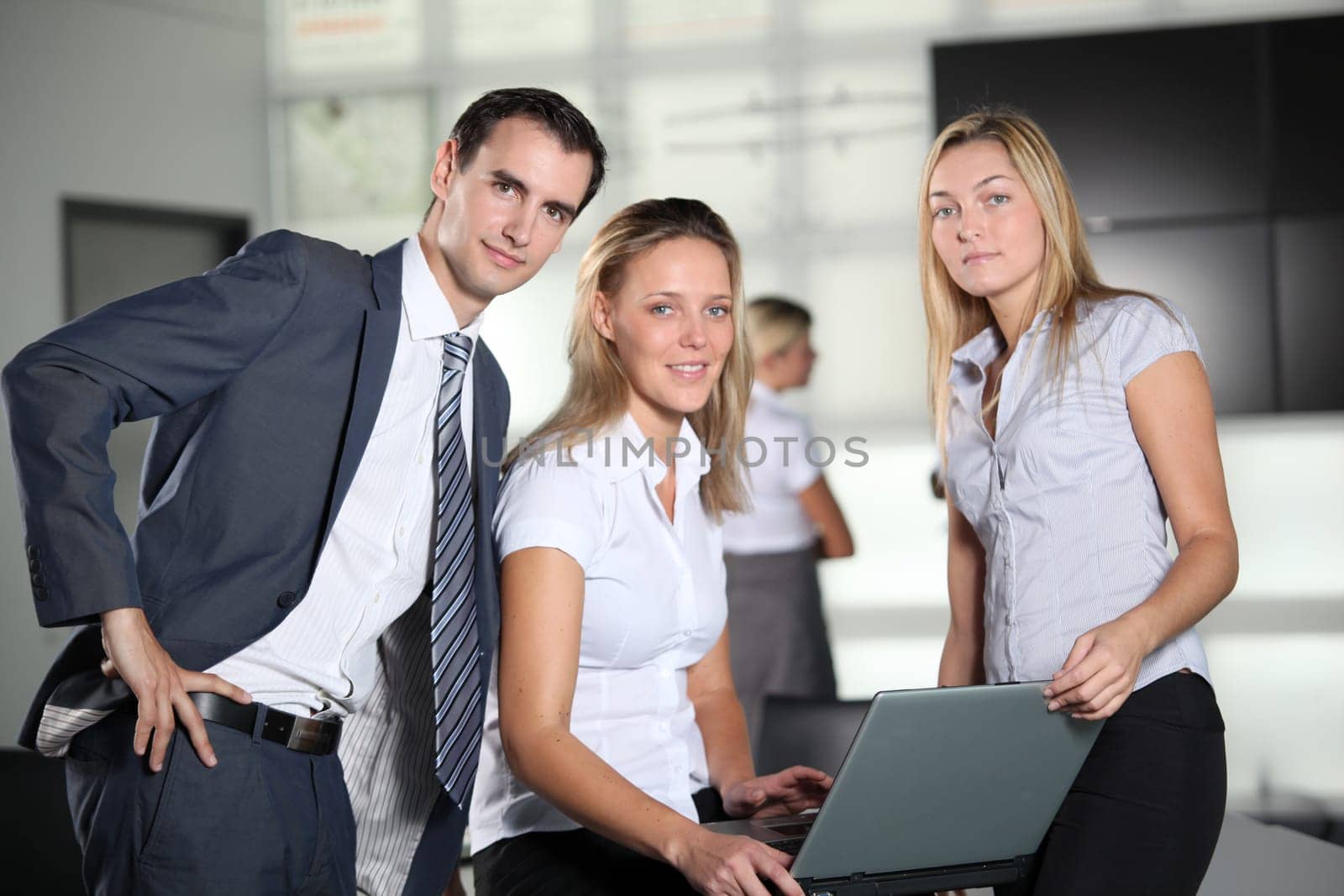Co-workers with laptop computer in the office