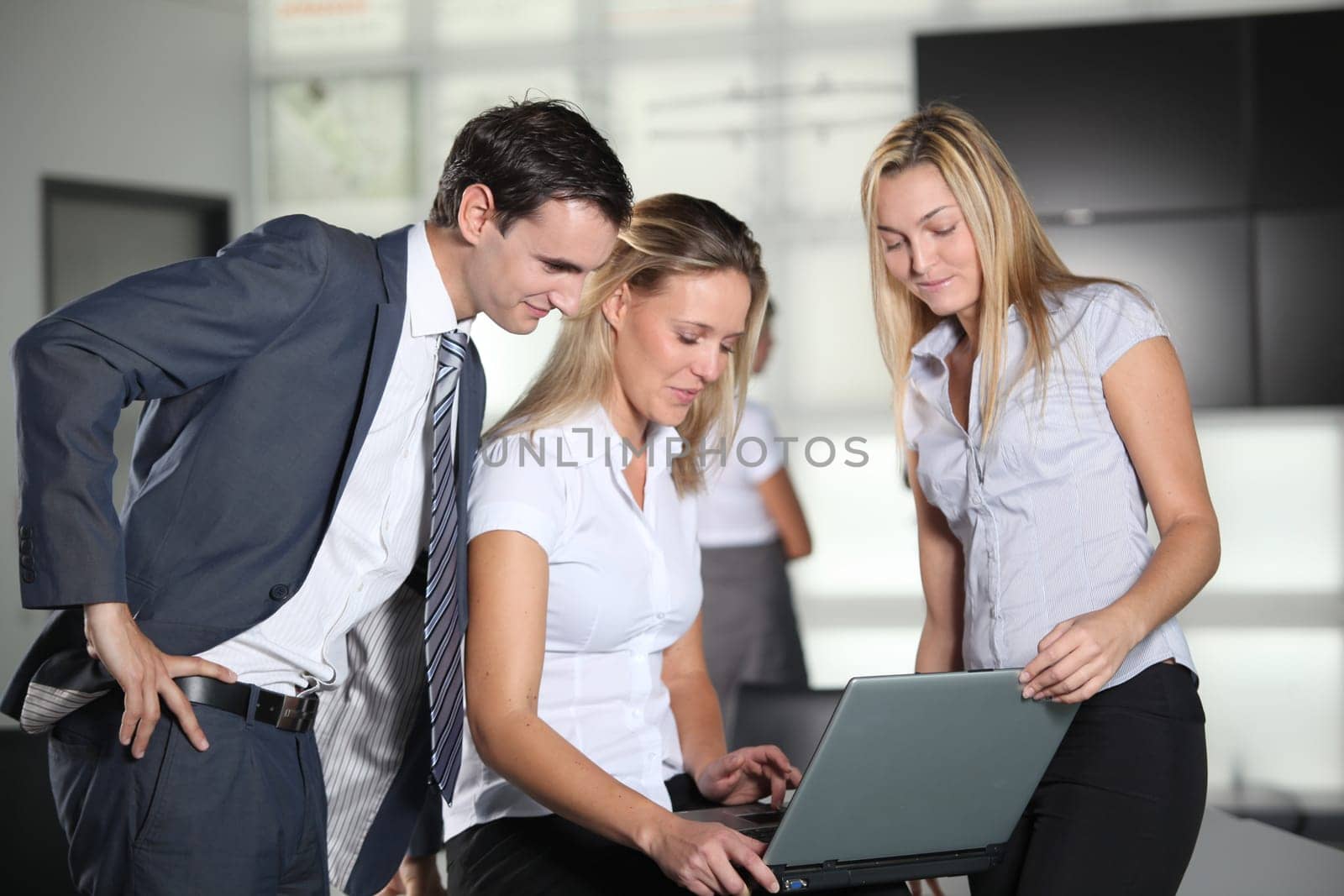 Co-workers with laptop computer in the office