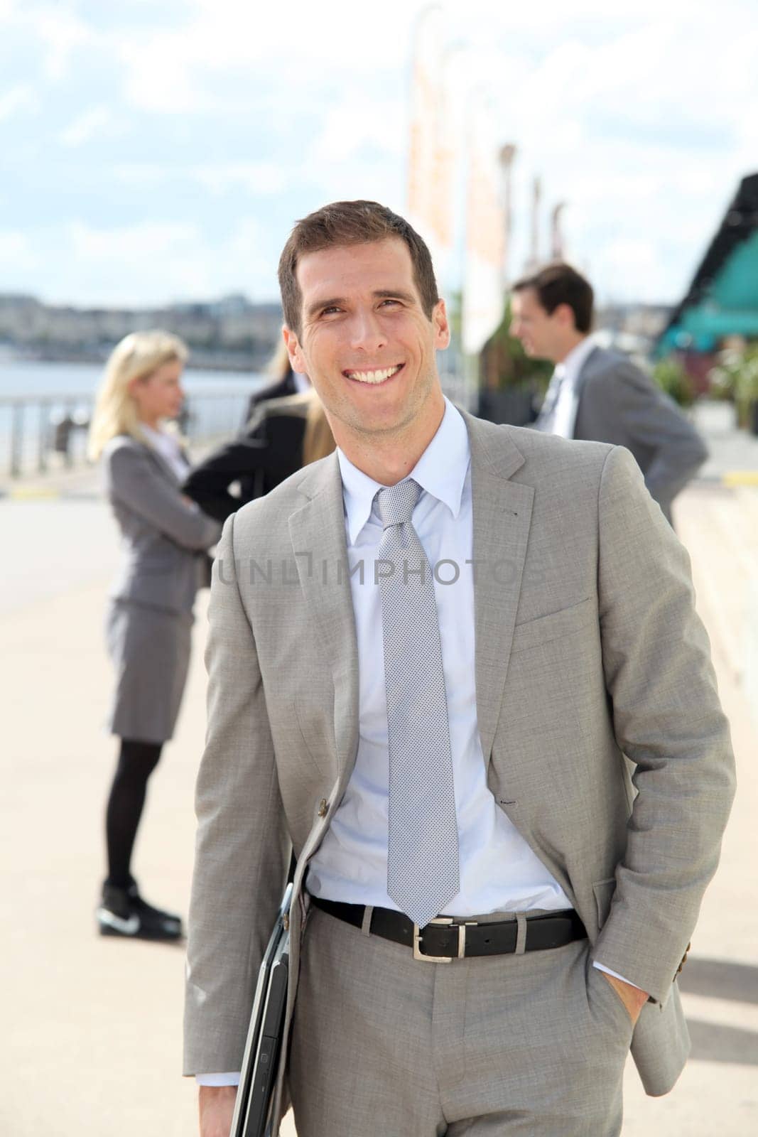 Businessman standing outdoors in the entrance of international fair
