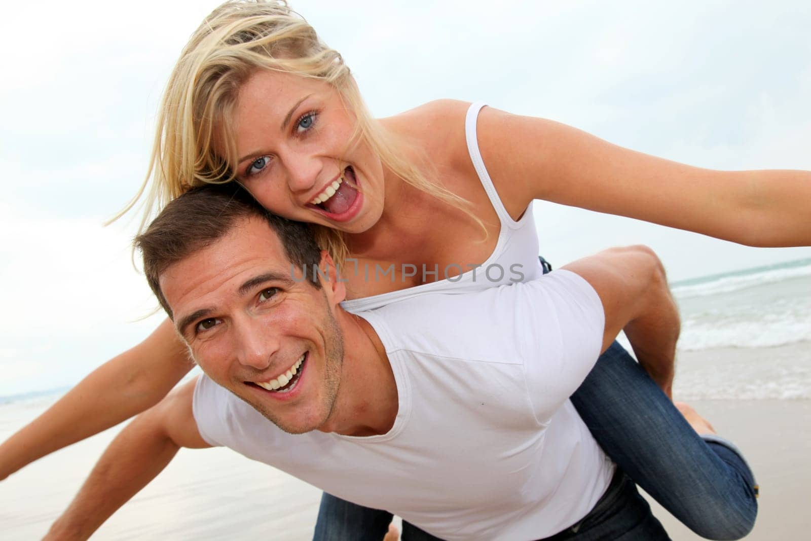 Happy couple enjoying vacation on a sandy beach