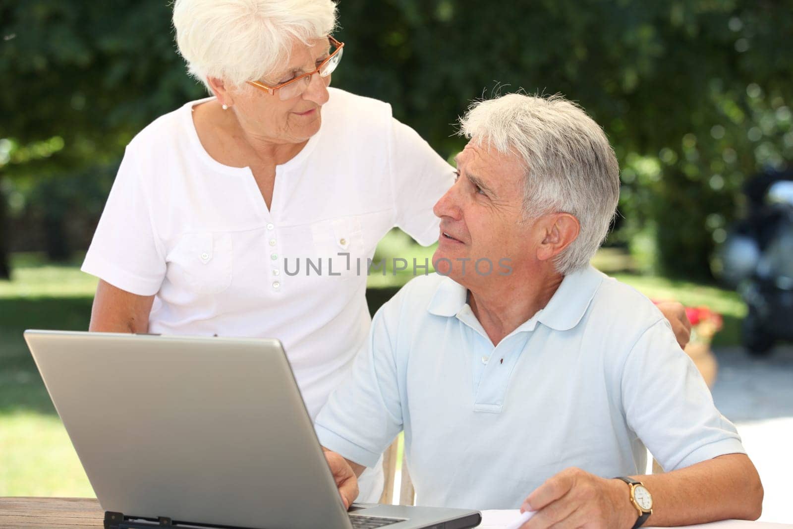 Senior couple using laptop computer at home