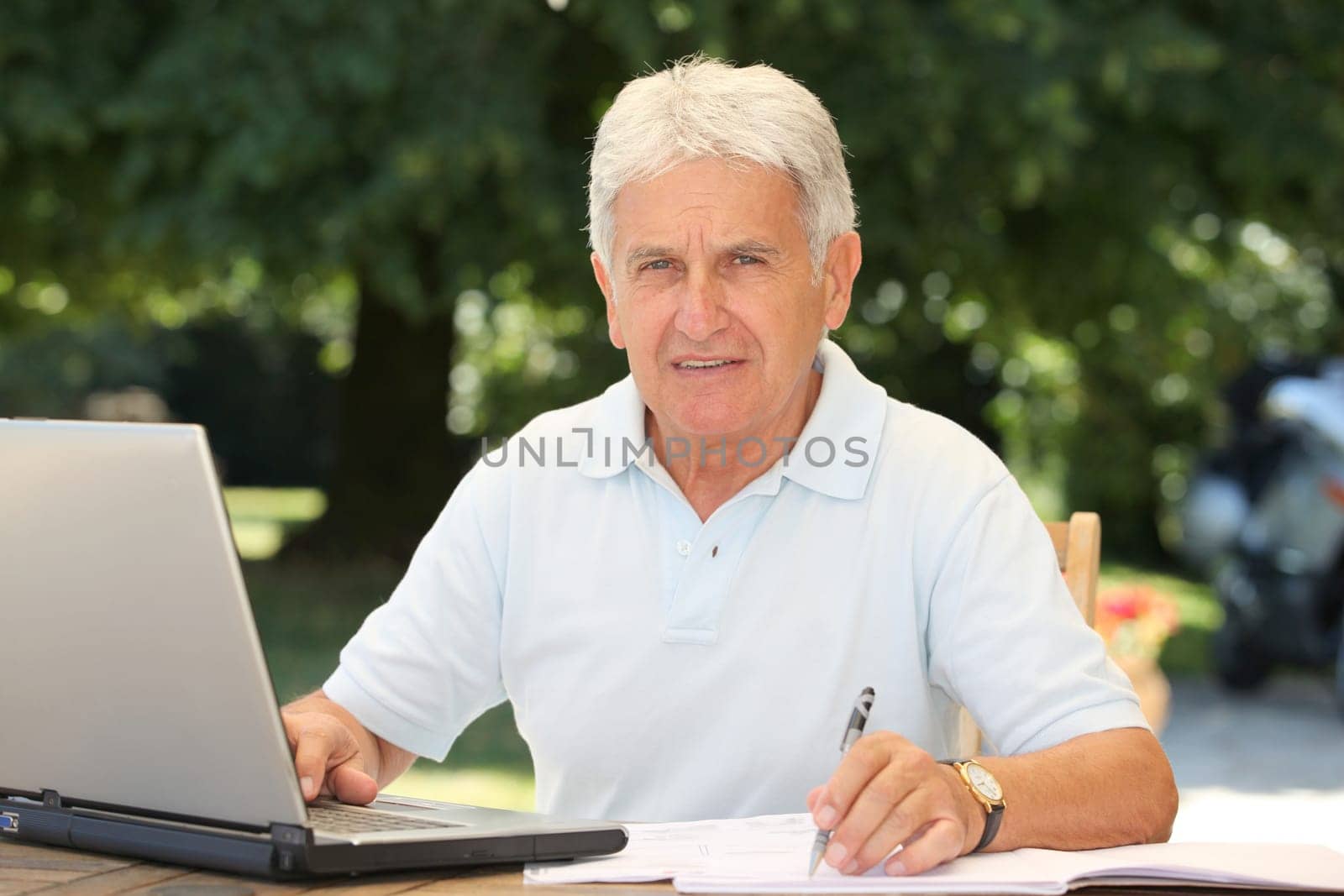 Closeup of senior man with laptop computer at home