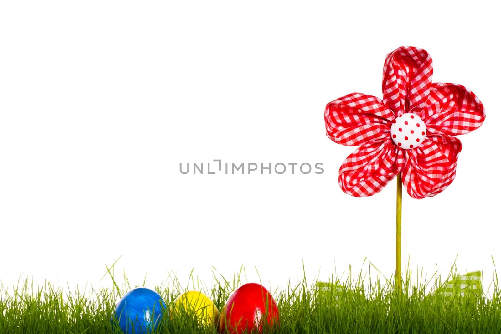 Easter eggs in grass with fabric flower