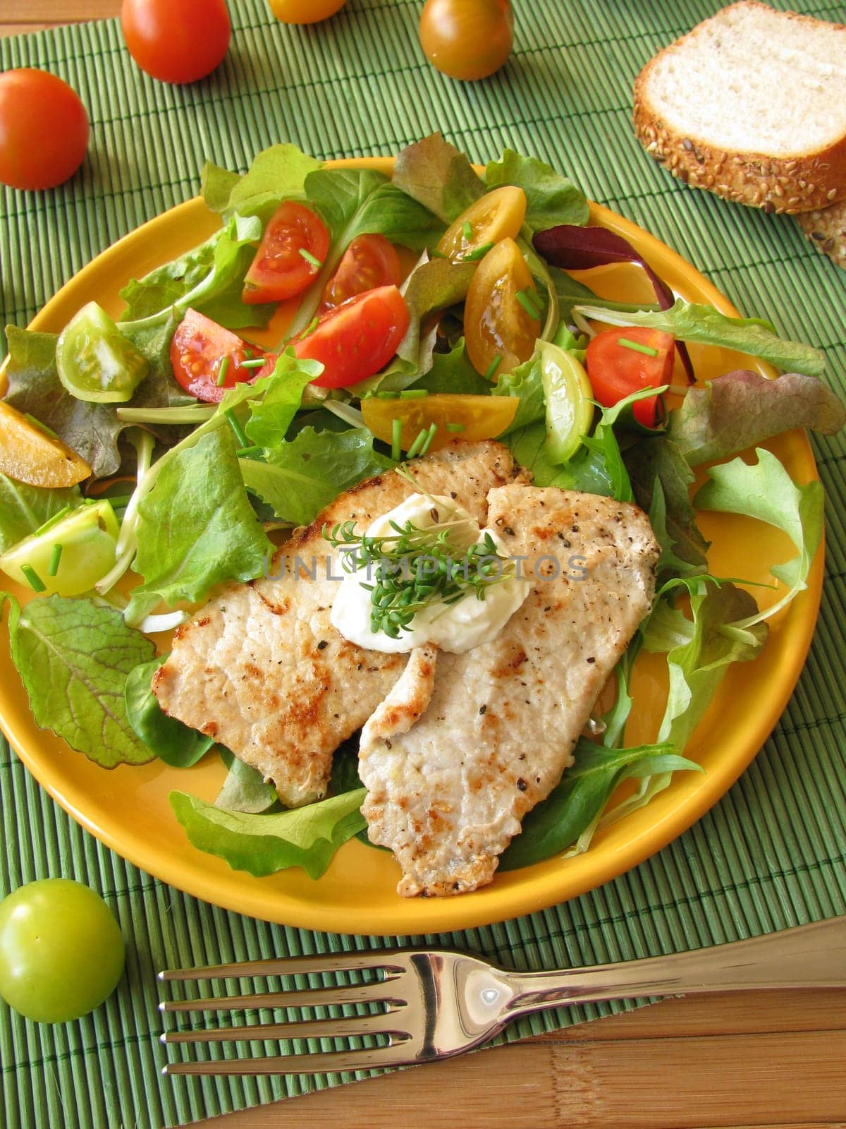 Schnitzel with lettuce and colorful tomatoes