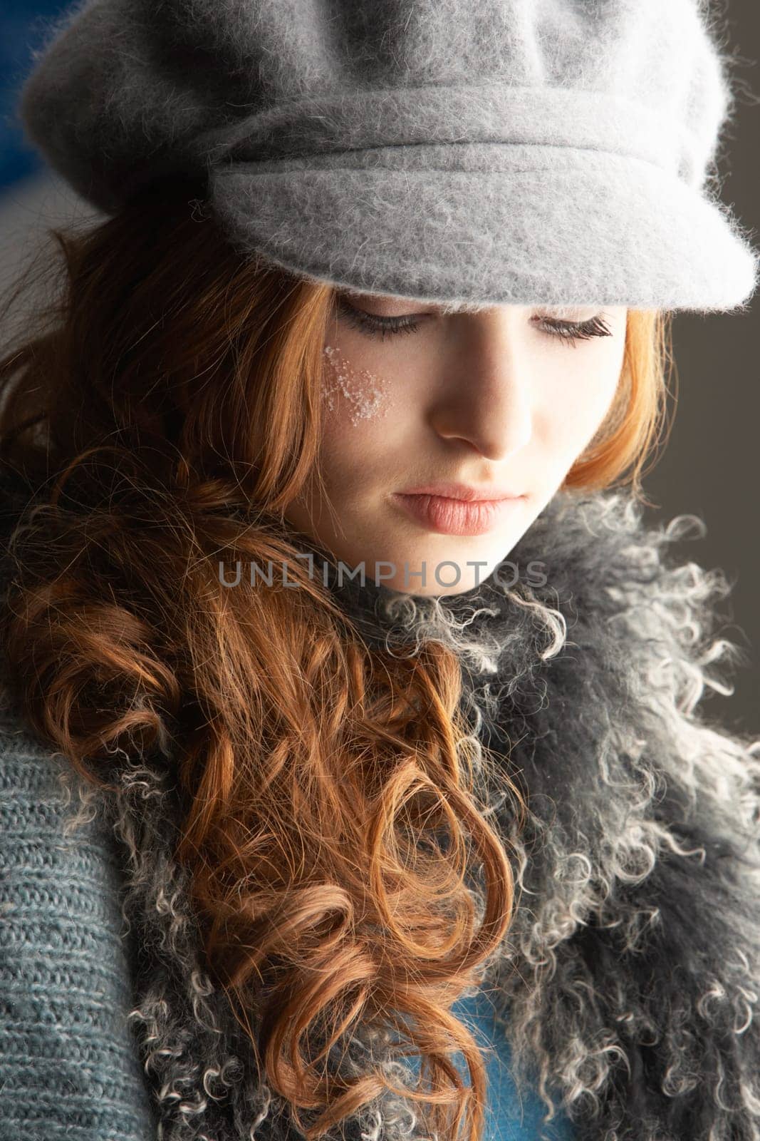 Fashionable Teenage Girl Wearing Cap And Knitwear In Studio
