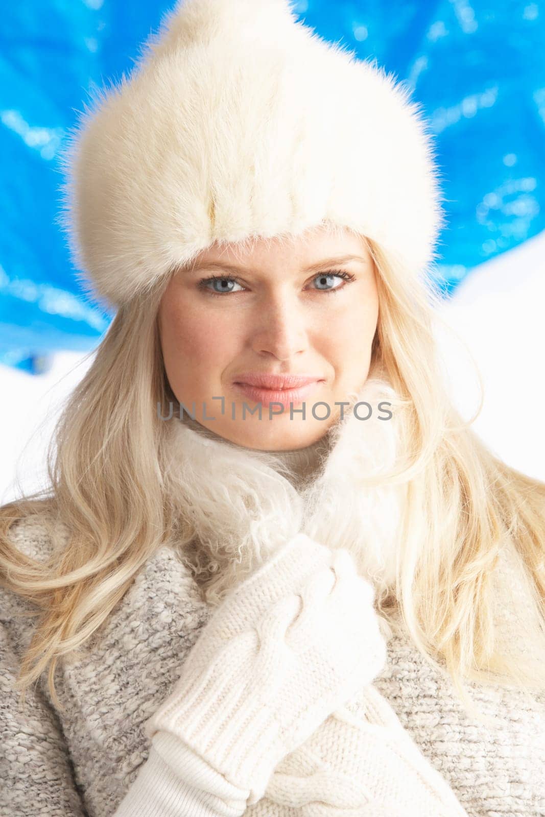 Young Woman Wearing Warm Winter Clothes And Fur Hat In Studio