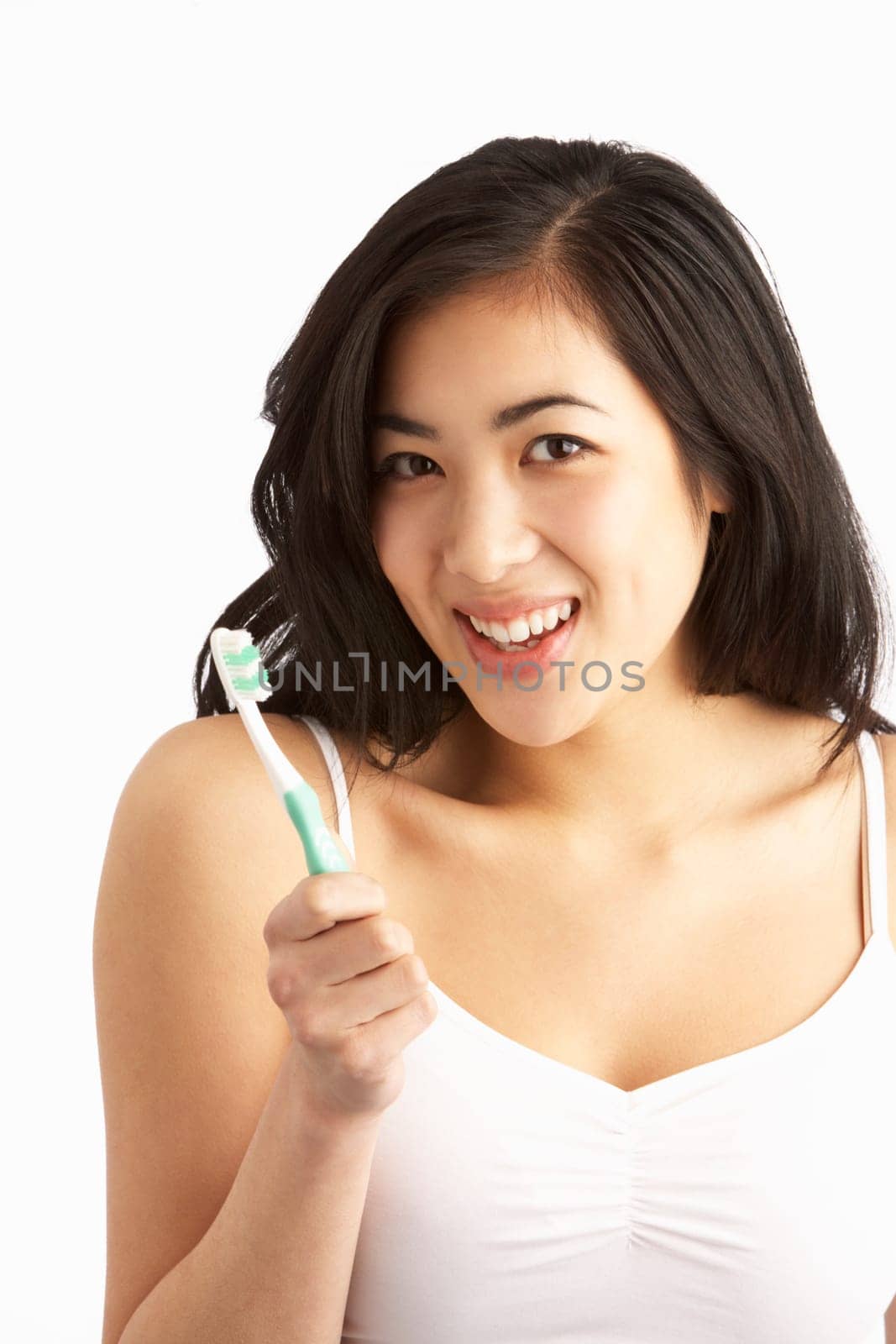 Young Woman Brushing Teeth In Studio