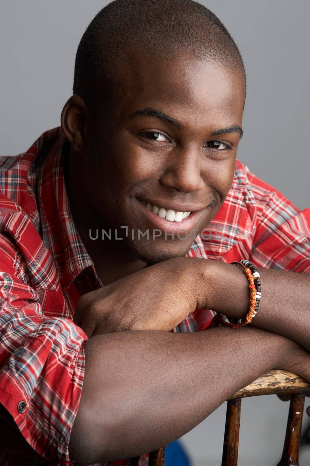 Fashionable Young Resting On Chair Man Wearing Casual Clothes In Studio