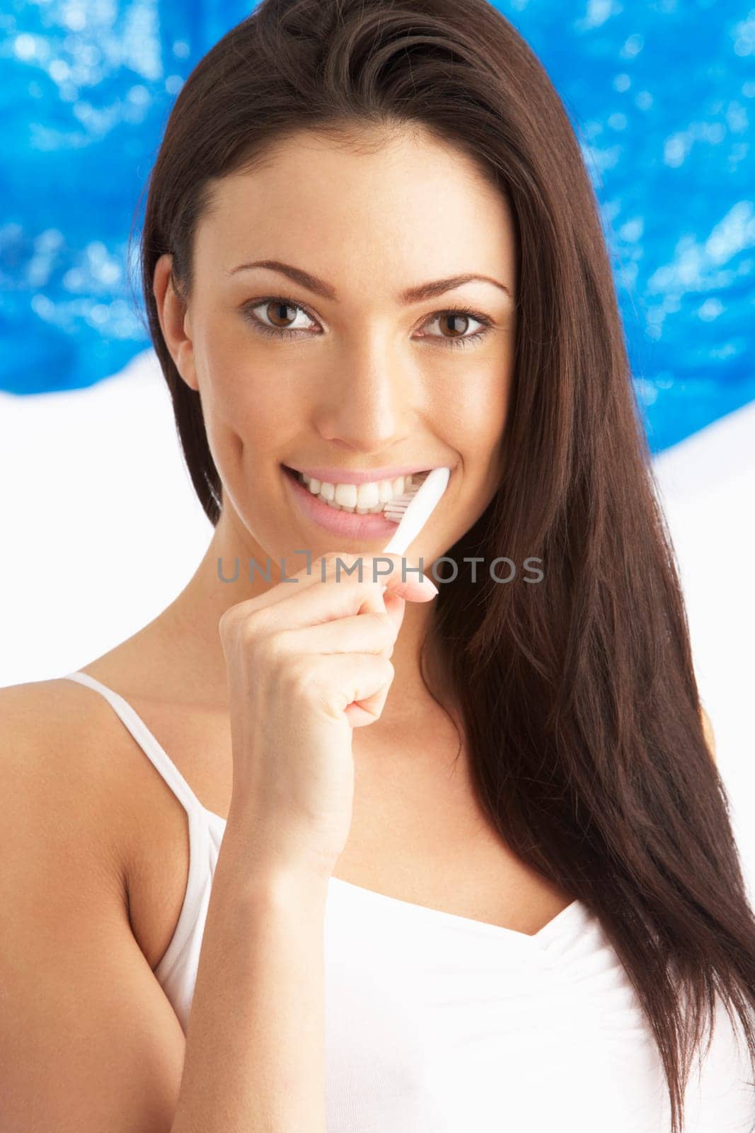 Young Woman Brushing Teeth In Studio