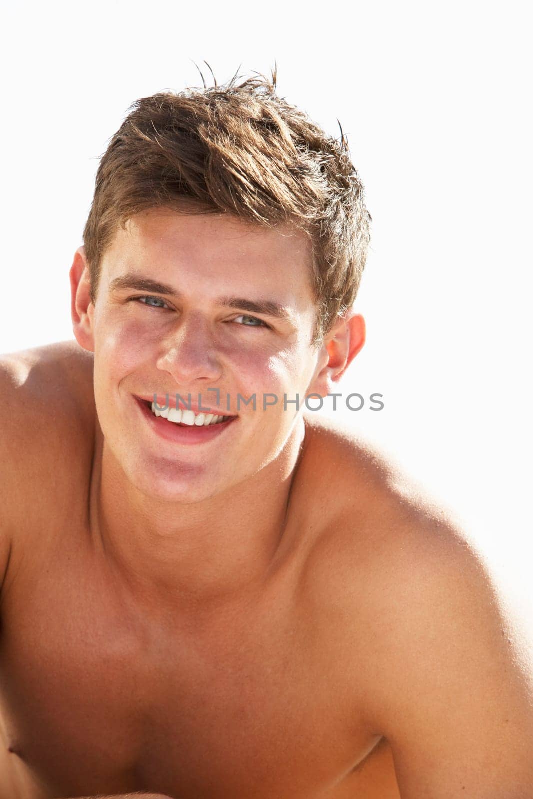 Teenage Boy Sitting On Beach