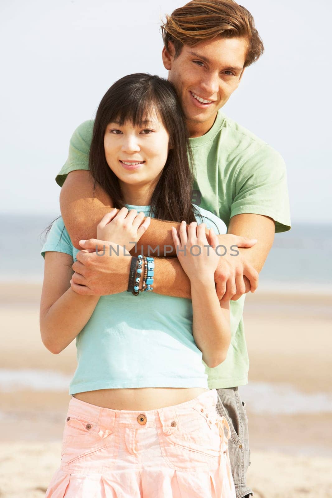 Romantic Young Couple Embracing On Beach