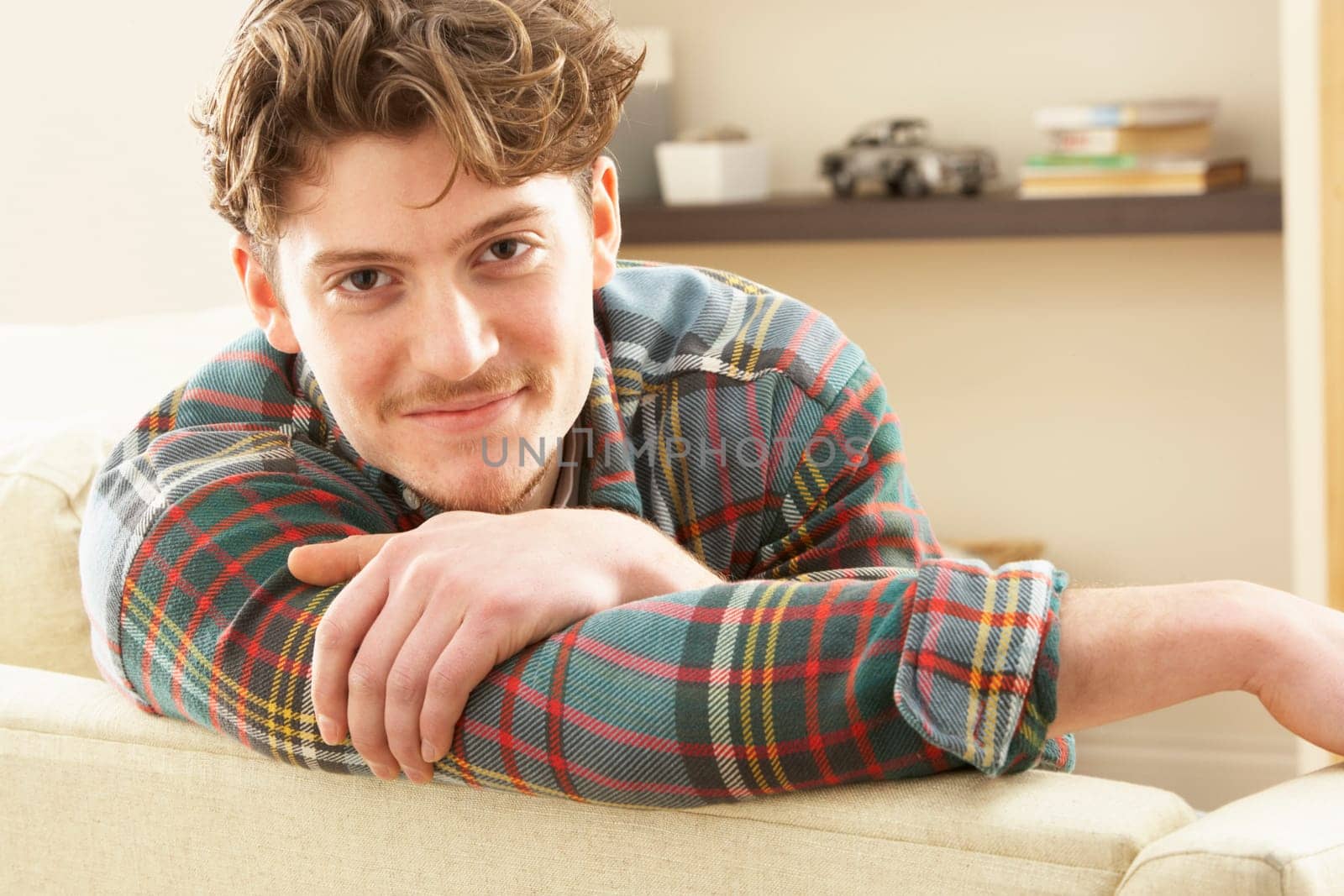 Man Relaxing On Sofa At Home