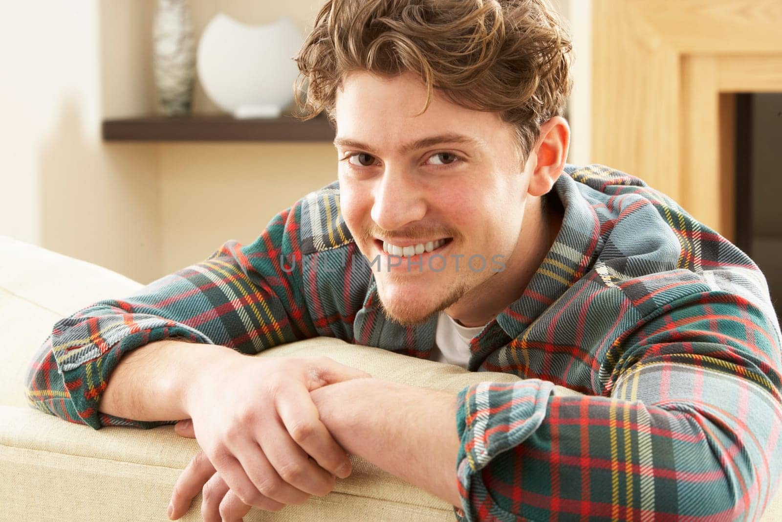 Man Relaxing On Sofa At Home