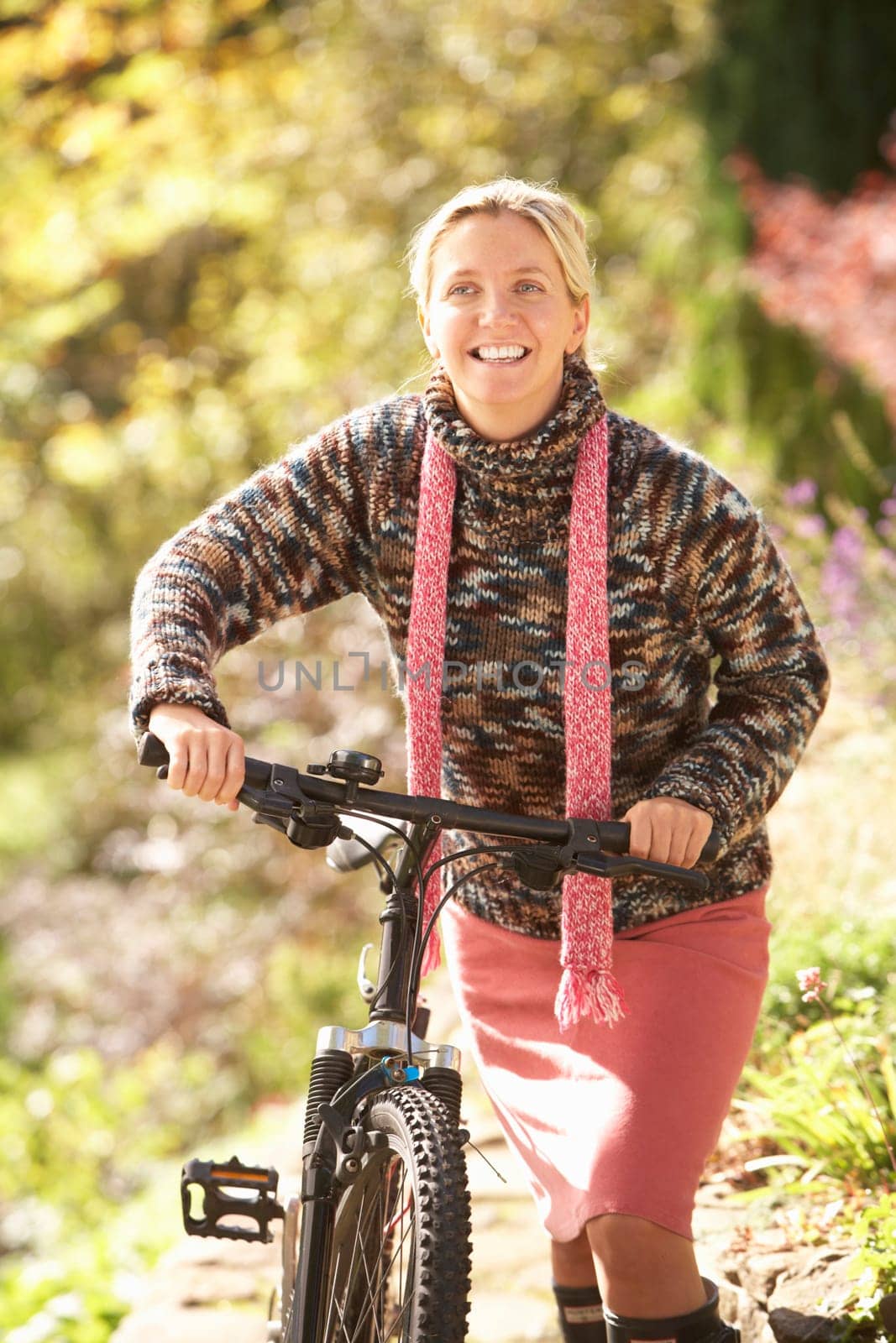 Portrait Of Young Woman With Cycle In Autumn Park