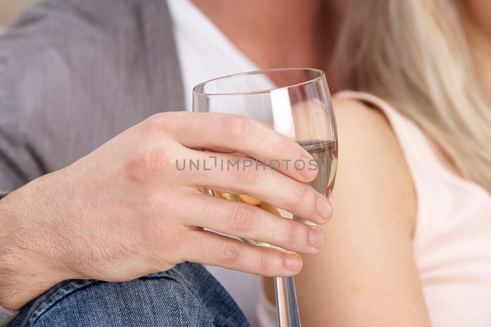 Close Up Of Hand Holding Glass Of White Wine