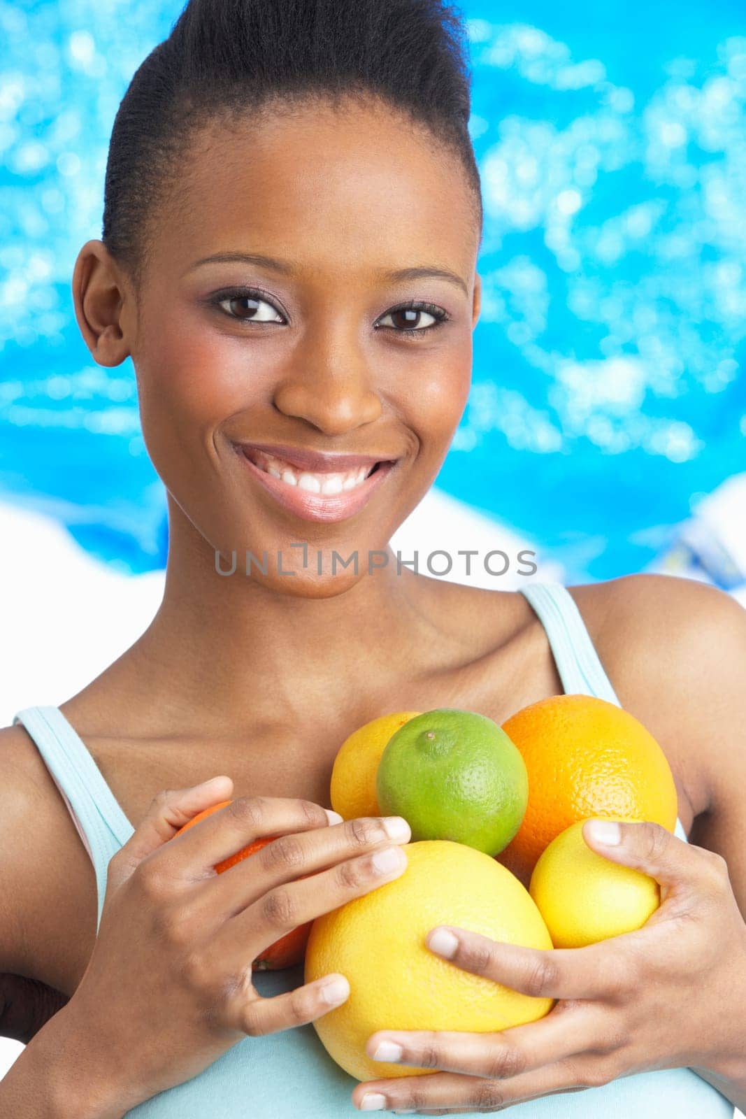 Young Woman Holding Citrus Fruit In Studio
