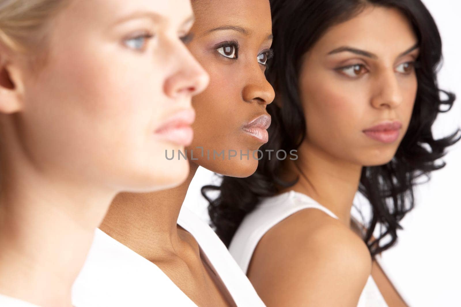Portrait Of Three Attractive Young Women In Studio Standing In Line