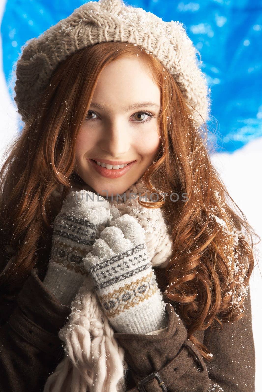 Teenage Girl Wearing Warm Winter Clothes And Hat In Studio