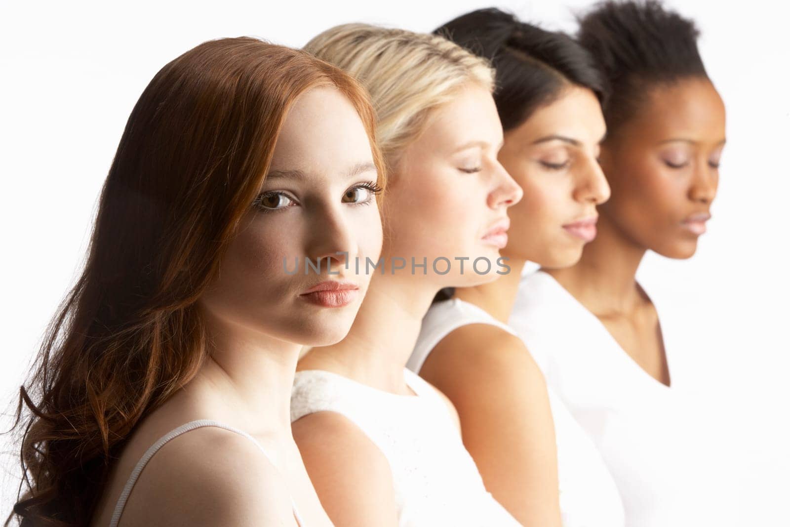 Portrait Of Four Attractive Young Women In Studio Standing In Line