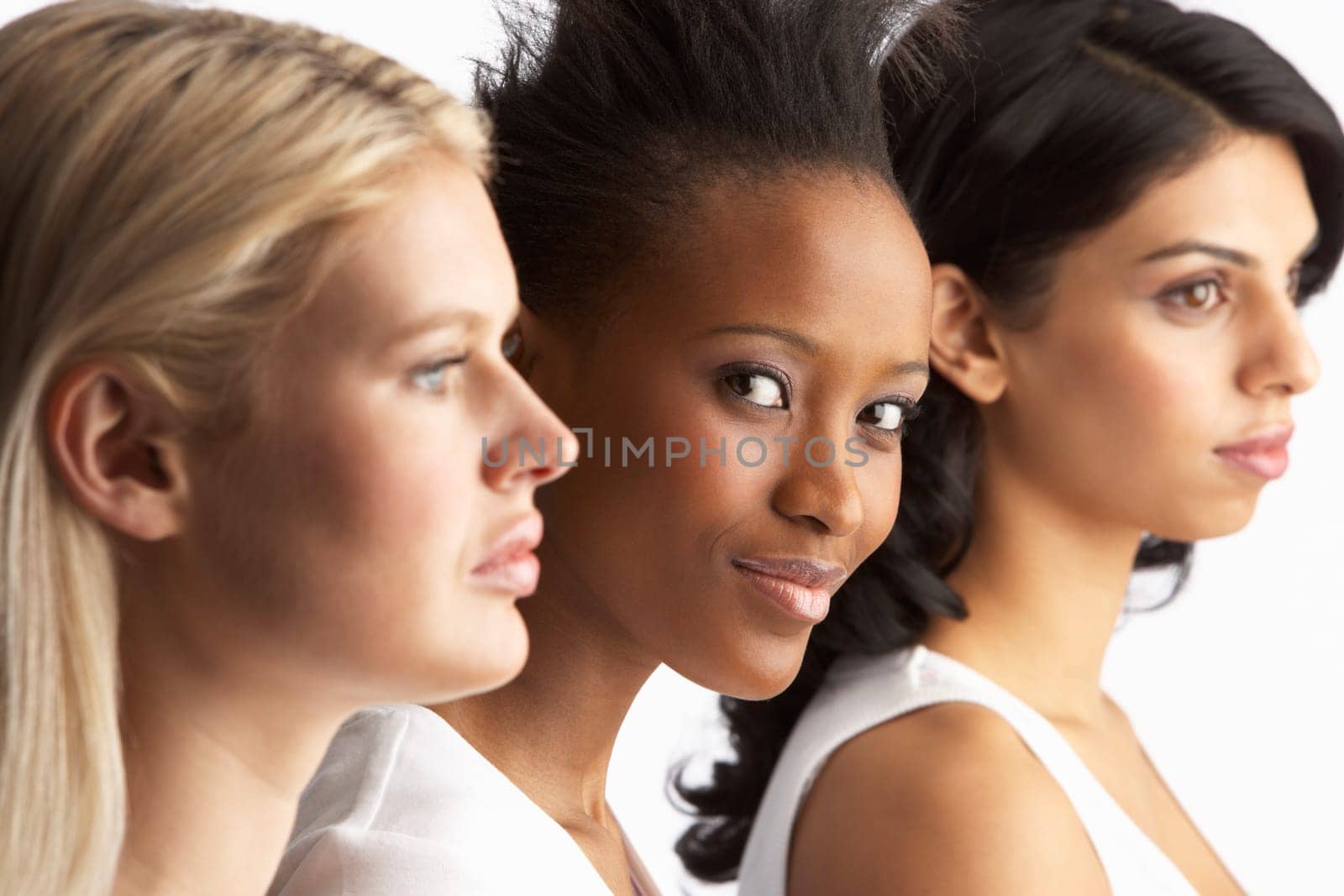 Portrait Of Three Attractive Young Women In Studio Standing In Line