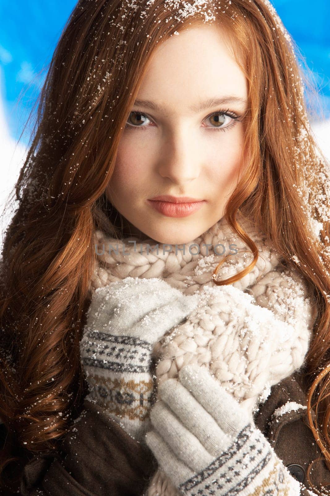 Teenage Girl Wearing Warm Winter Clothes And Hat In Studio