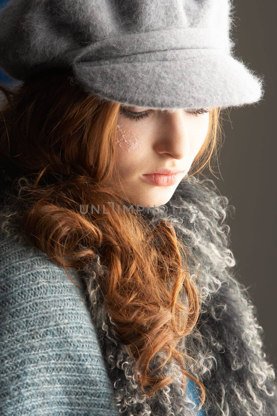 Fashionable Teenage Girl Wearing Cap And Knitwear In Studio