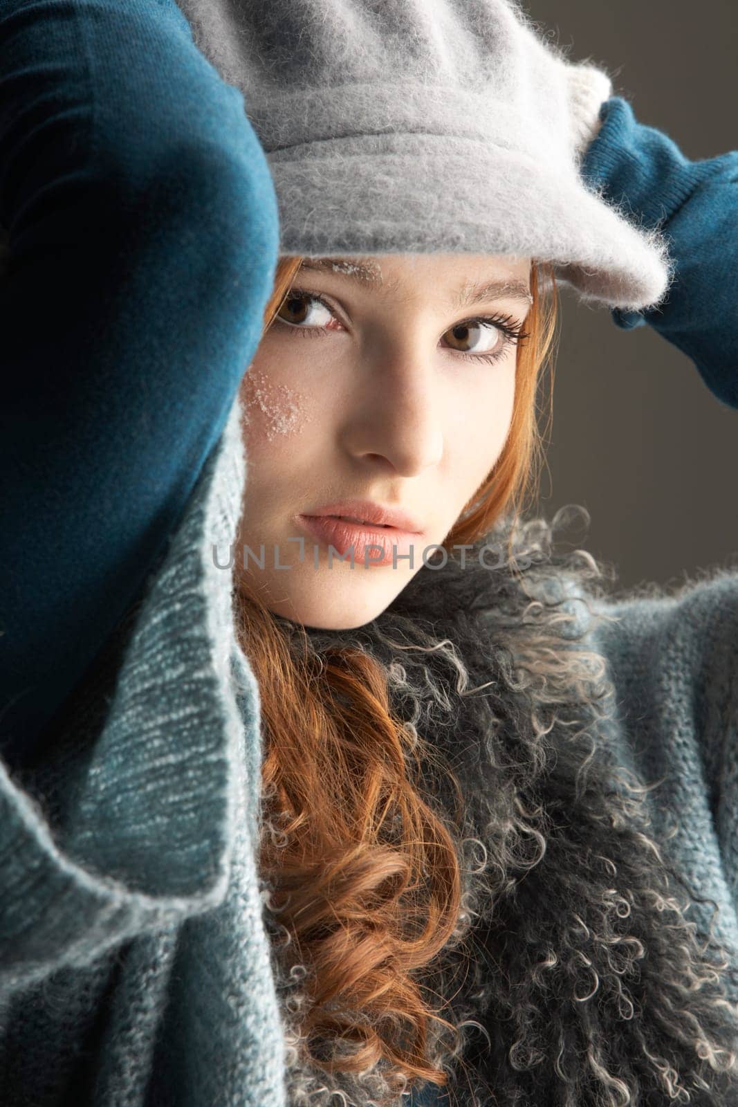 Fashionable Teenage Girl Wearing Cap And Knitwear In Studio