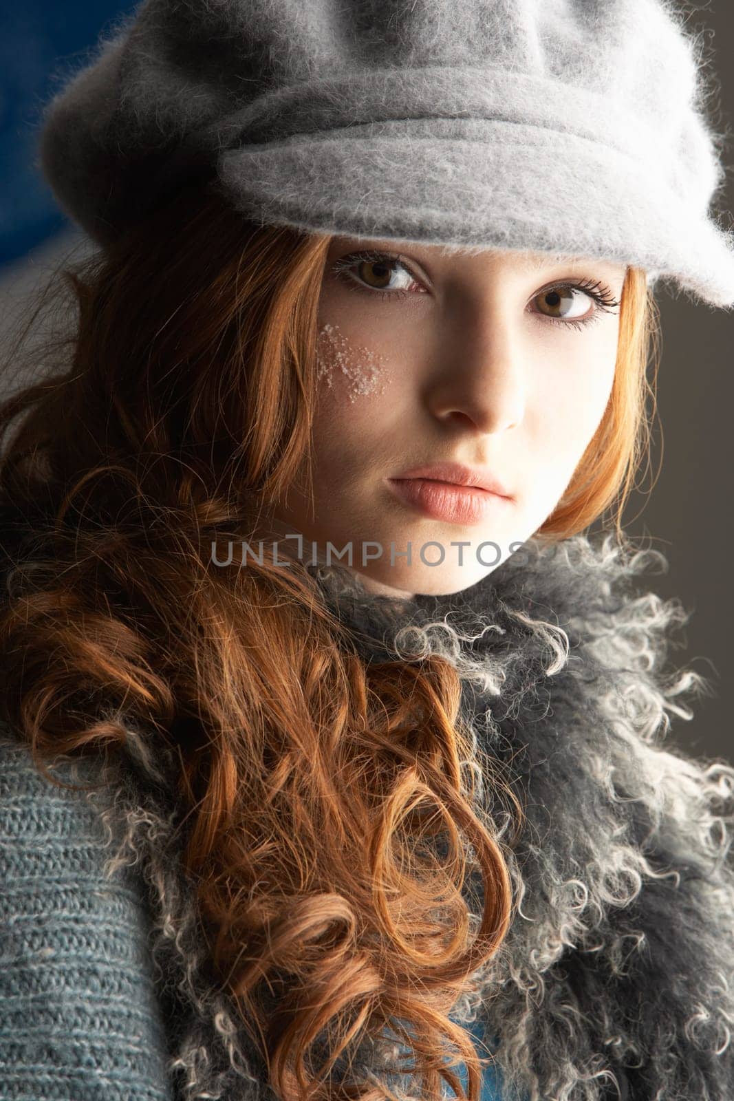 Fashionable Teenage Girl Wearing Cap And Knitwear In Studio